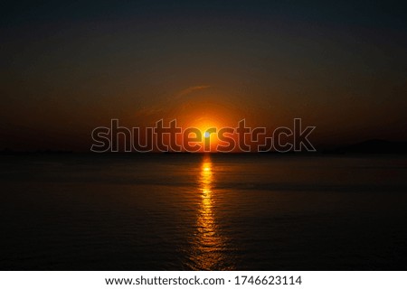 A sunset over a body of water. High quality photo