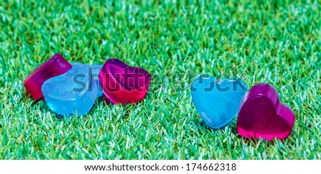 Heart-shaped soap on green grass
