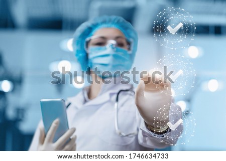 Doctor clicks on completed tasks on a blurred background.