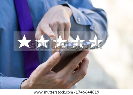 5 star rating or review in survey. Customer man hands holding smart phone Rate your experience, giving positive feedback, questionnaire or customer satisfaction research. Royalty-Free Stock Photo #1746644819