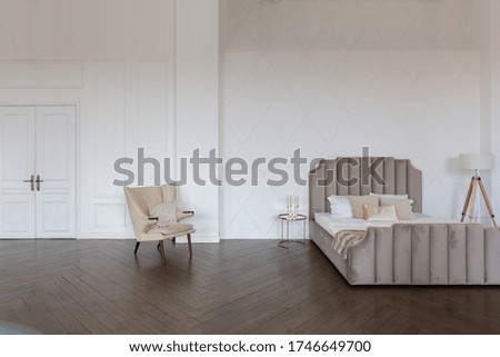 Modern luxury stylish apartment interior in pastel colors. a very bright room with huge windows filled with daylight. white walls, wooden parquet floors.