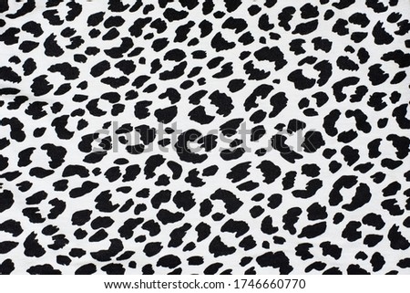 Black spots of different shapes on white background - imitation of dolmatine dog skin, close up