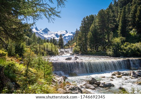 Gorgeous nature of the Roseg Valley in September. It is a valley of the Swiss Alps, located on the north side of the Bernina Range in Graubünden The valley is drained by the Ova da Roseg river Royalty-Free Stock Photo #1746692345