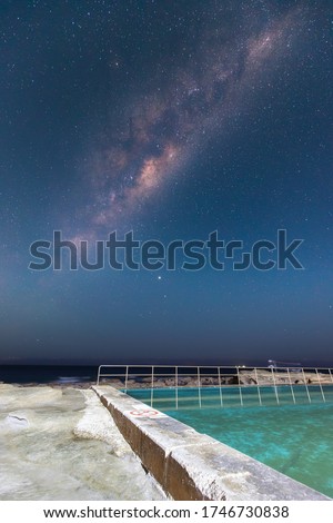 Milky way view over Coalcliff rock pool at night, NSW, Australia.