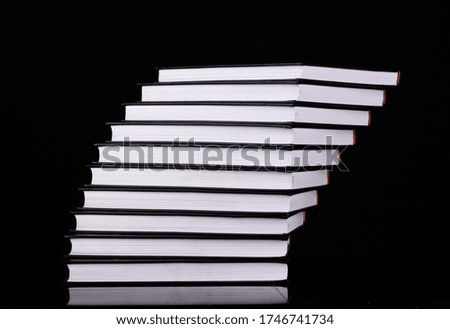 pile of white books isolated black background