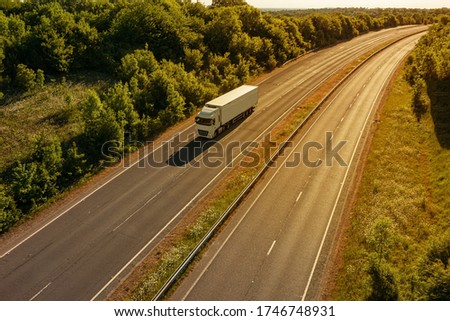Lonely lorry on the motorway during sunset Royalty-Free Stock Photo #1746748931