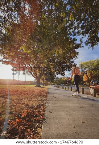 Girl riding a longboard on park