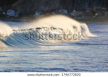 Waves breaking in Japan. The Pacific ocean & its waves often generated by a Typhoon. Stunning coastline of Japan, Travellers like to visit the beach & watch the swell turn into waves & break