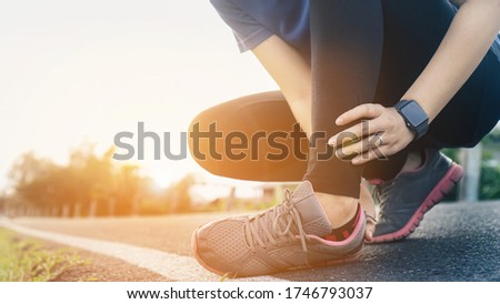 Ankle twist sprain accident in sport exercise running jogging.sprain or cramp Overtrained injured person when training exercising or running outdoors. Royalty-Free Stock Photo #1746793037