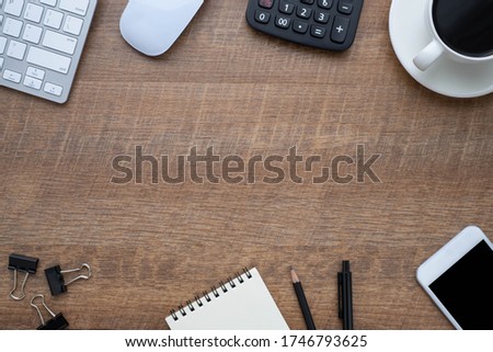 Workspace in office with wood table. Top view from above of keyboard with notebook and coffee. Desk for modern creative work of designer. Flat lay with blank copy space. Business and finance concept.