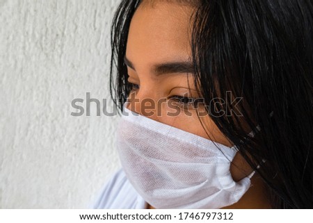 A young brunette female with a medical mask