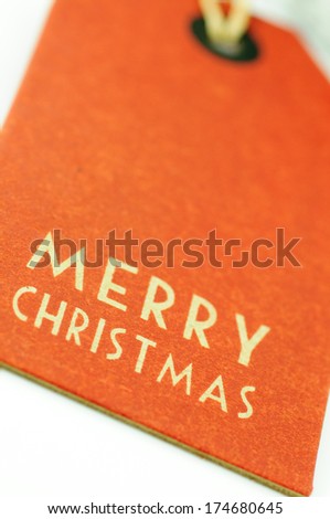 Merry Christmas label old orange with shallow depth of field