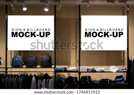 Mock up two blank horizontal signboard with clipping path on showcase of winter cloths showroom with spot light in shopping mall, empty space for insert advertising graphic or text information 