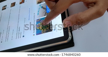 Image of searching about Covid 19, Corona virus on tablet screen 