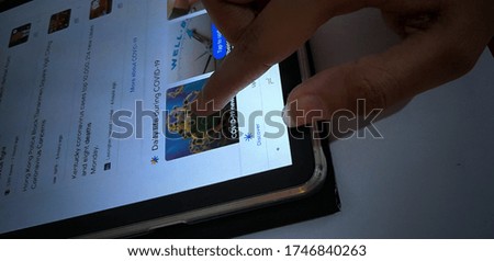 Image of searching about Covid 19, Corona virus on tablet screen 