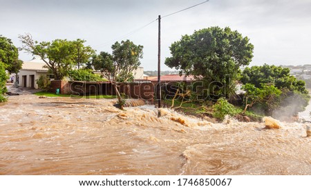 Floodwaters in the town of Bushmans River in the Eastern Cape of South Africa. Royalty-Free Stock Photo #1746850067
