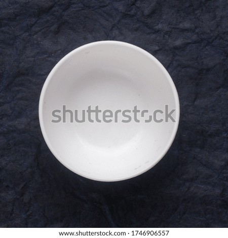 White ceramic plate on blue background