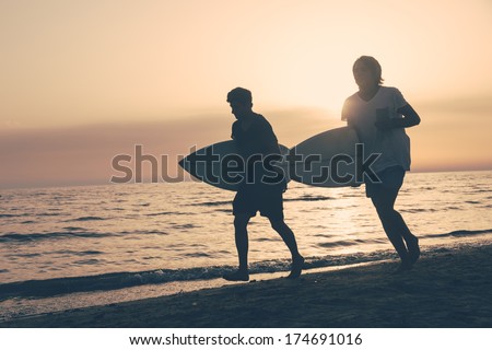 Two Boys with Surf Boards at Sunset