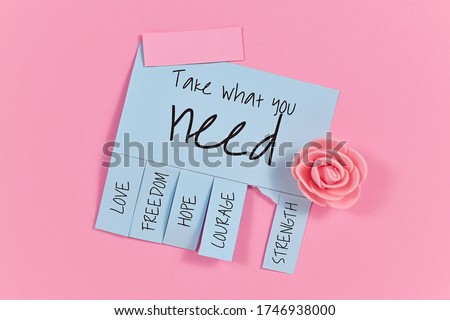 Blue tear-off stub note with text 'Take what you need' and words 'Love, Freedom, Hope, Courage' and 'Strength' on pink background Royalty-Free Stock Photo #1746938000