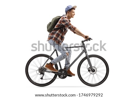 Profile shot of a male student riding a bicycle isolated on white background