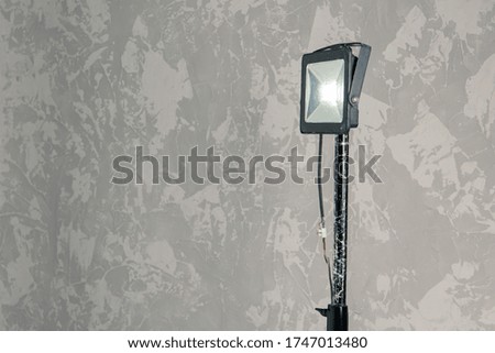 studio lighting rustic lamp hand made illumination object inside room with design painted wall background, empty copy space 