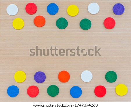 Various multi-colored geometric shapes on a wooden background. View from above. Background for text. Copy space