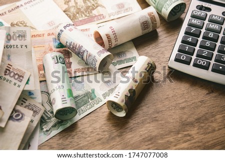 Russian Ruble money with calculator on wood table background for financial and investment concepts