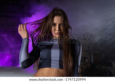 Cinematic night portrait of woman in  neon. High Fashion model girl in colorful bright neon lights posing in studio, portrait of beautiful woman in  top