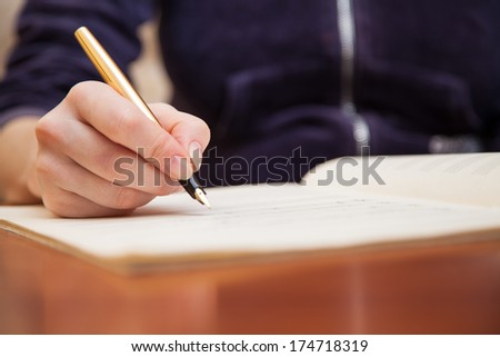  Hand pointing with pen to music book with handwritten notes