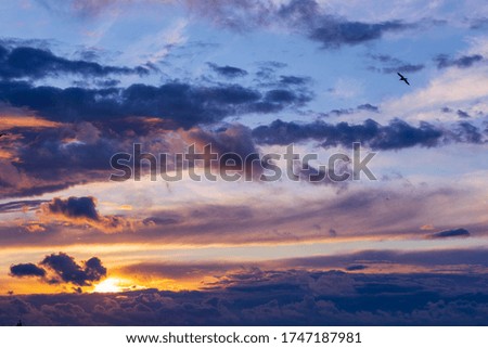 amazing sunset clouds with blue sky. Reflection of sunlight on the sea