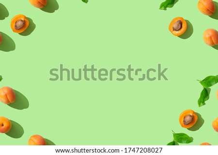 Fresh orange apricots on green background. Copy space for text. Wallpaper, sale, discount, natural cosmetics banner background