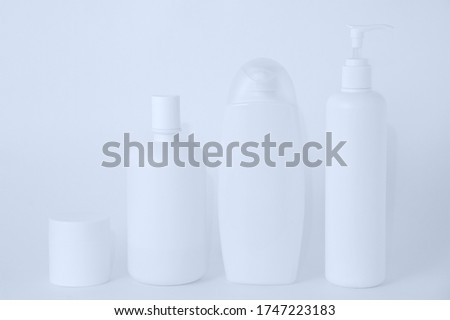 White plastic bottles with cosmetics on a white background.