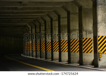 Road tunnel with traffic signs.