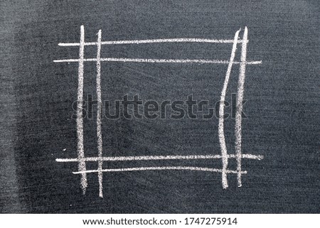 White color chalk hand drawing in square shape on black board background