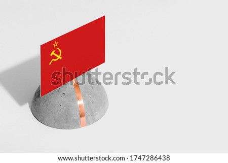 Soviet Union flag tagged on rounded stone. White isolated background. Side view minimal national concept.