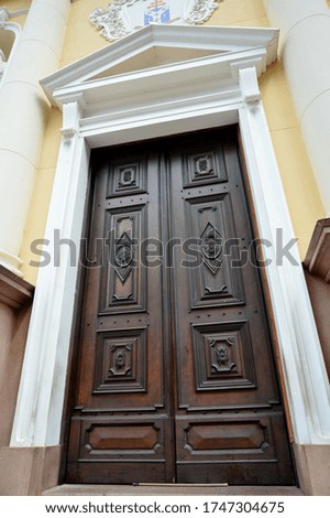 
large wooden door of a church in brown color