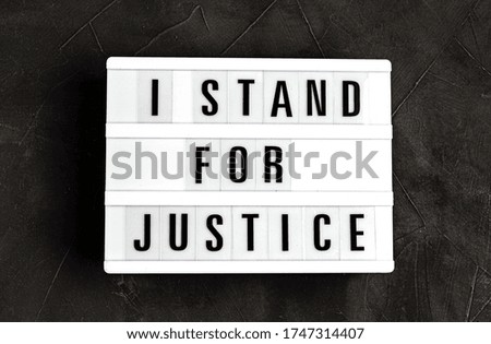 I stand for justice text on light box over dark background