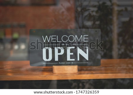 Text on vintage black sign "Come in we're open" in cafe and restaurant.