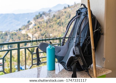 Picture of trecking bagpack and metal bottle for water. Travel, trecking, hiking concept. Stock photo
