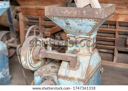 Blue rice paddy mill machine to make white rice grain That has been used for a long time until rusting in the rice mill