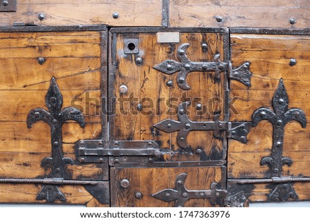 Ancient fixed lock with keyhole on old wooden doors