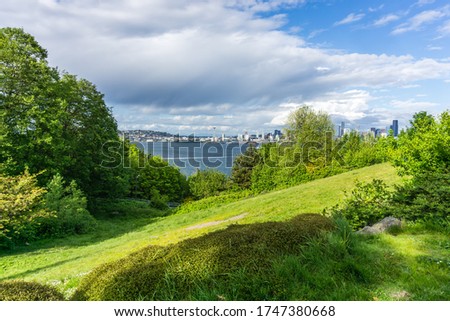 A view of a grassy hill an the Seattle skyline from West Seattle, Washington.