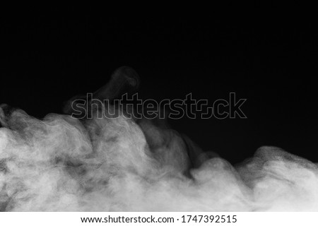 Blur white water vapour on isolated black background. Abstract of steam with copy space. Steam flow. Smoke on white background. Royalty-Free Stock Photo #1747392515