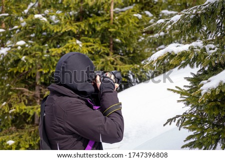Woman Photographer Hiker In Snowy Mountain, In Search Of Best Picture to Take
