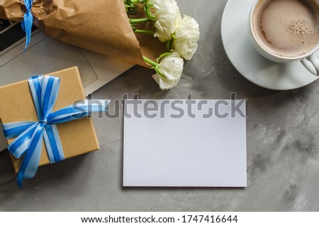 Mock up of greeting card with laptop computer, gift box, morning coffee and flowers. Father's day or birthday concept.