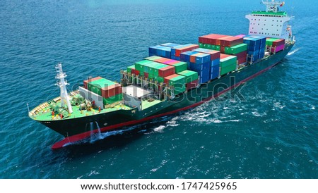 Aerial drone photo of colourful truck size container tanker ship cruising Aegean deep blue sea