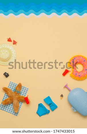 Summer relax vacation background. Starfish in sunglasses lying on the beach near accessories. Yellow background with blank space for text.