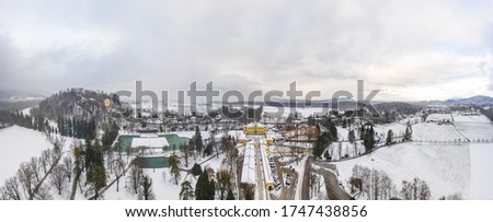Aerial view of Schloss Hellbrunn covered in snow near Salzburg outskirts in winter time