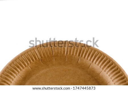 Eco natural plate with empty space. Disposable ecological utensils on white background. Sustainability of planet. Closeup isolated cardboard plate made of fiber of bamboo and bagasse.