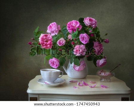 Still life with bouquet of pink roses on tea table